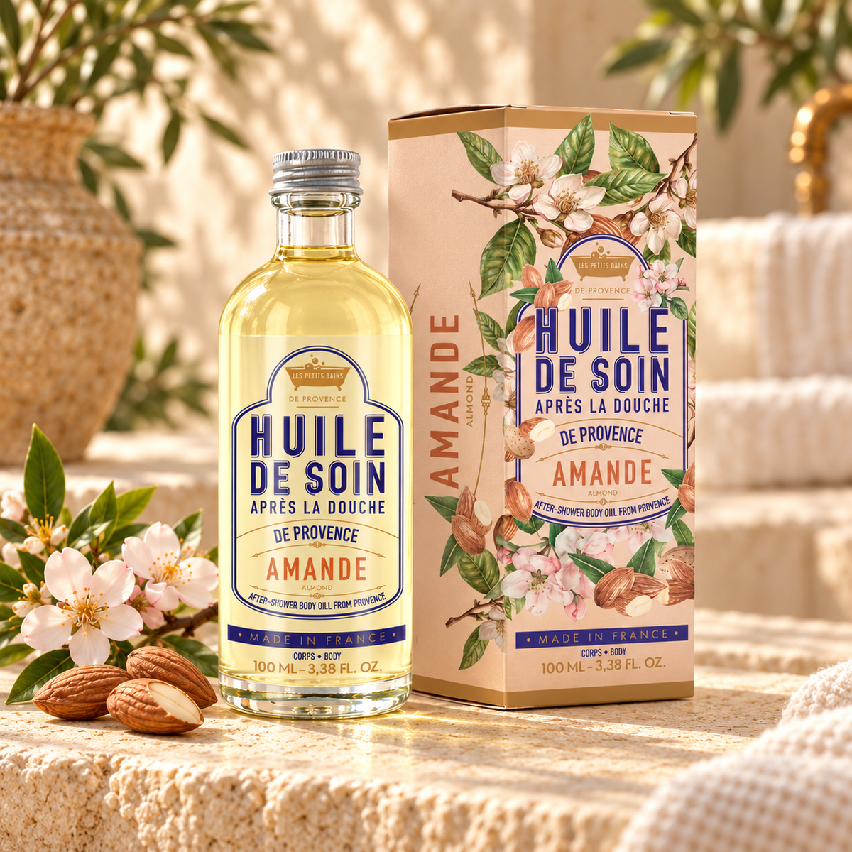 Huile de soin Amande 100 ml avec sa boîte, des amandes et des fleurs d’amandier dans un décor provençal
