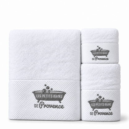 Les trois serviettes blanches brodées, grande à gauche et deux petits formats à droite